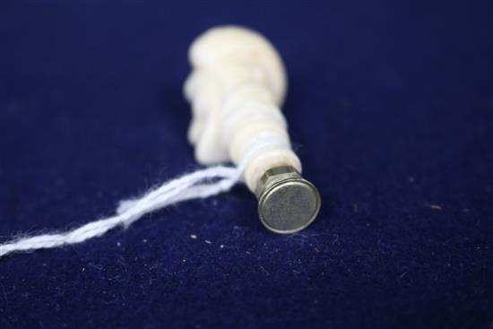 A carved ivory seal, a bone bodkin case and a miniature ivory handled cork screw